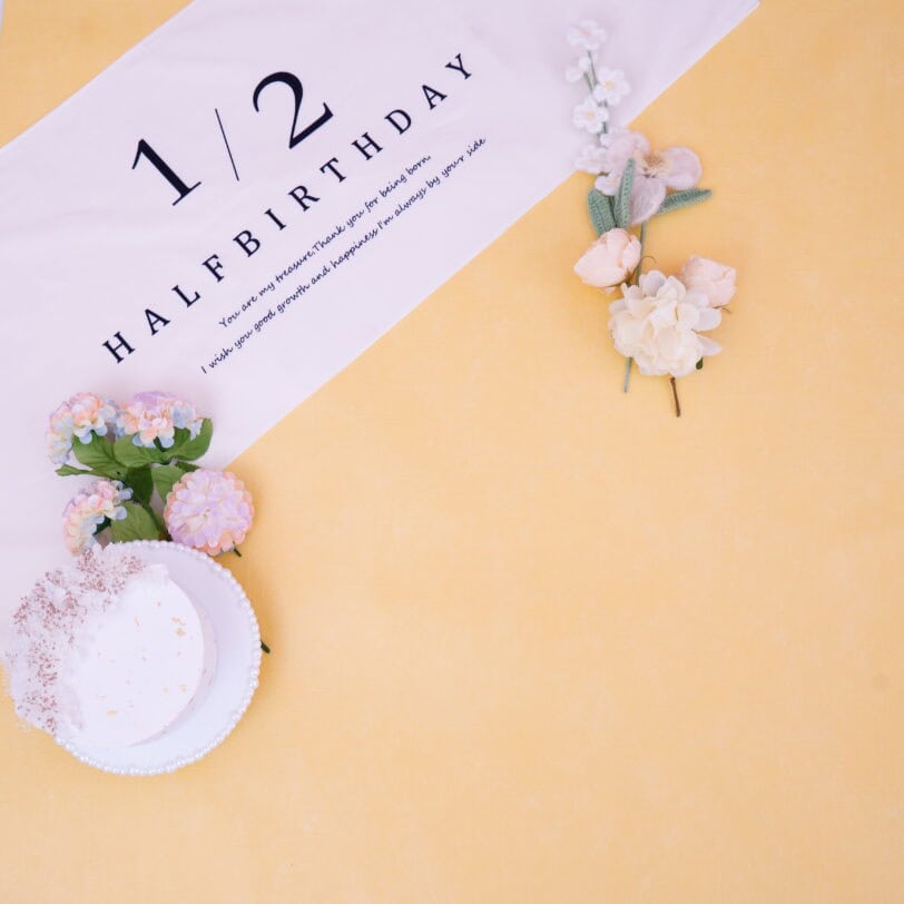 背景色黄色のハーフバースデーのベビーフォト